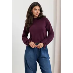 Dzianinowy sweter z kokardkami na rękawach